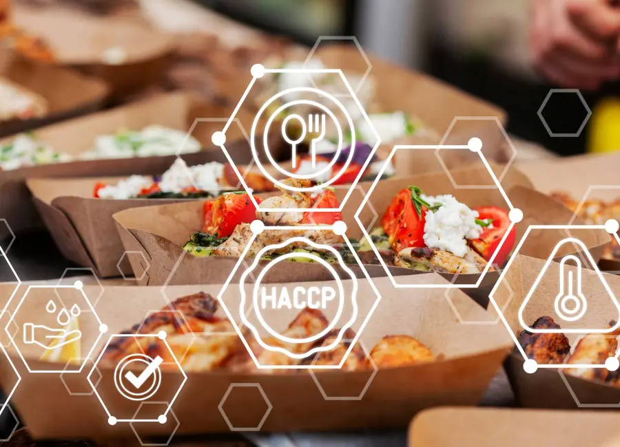 Prepared meal trays with HACCP, hygiene, temperature, and food safety icons illustrating food safety controls.