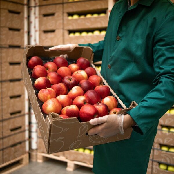 Person holding an apple crate.