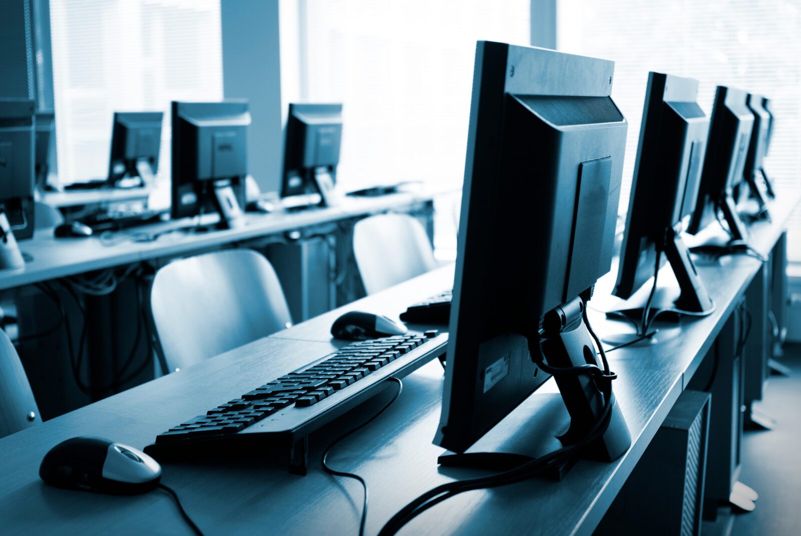 Rows of desk and computers in a training lab