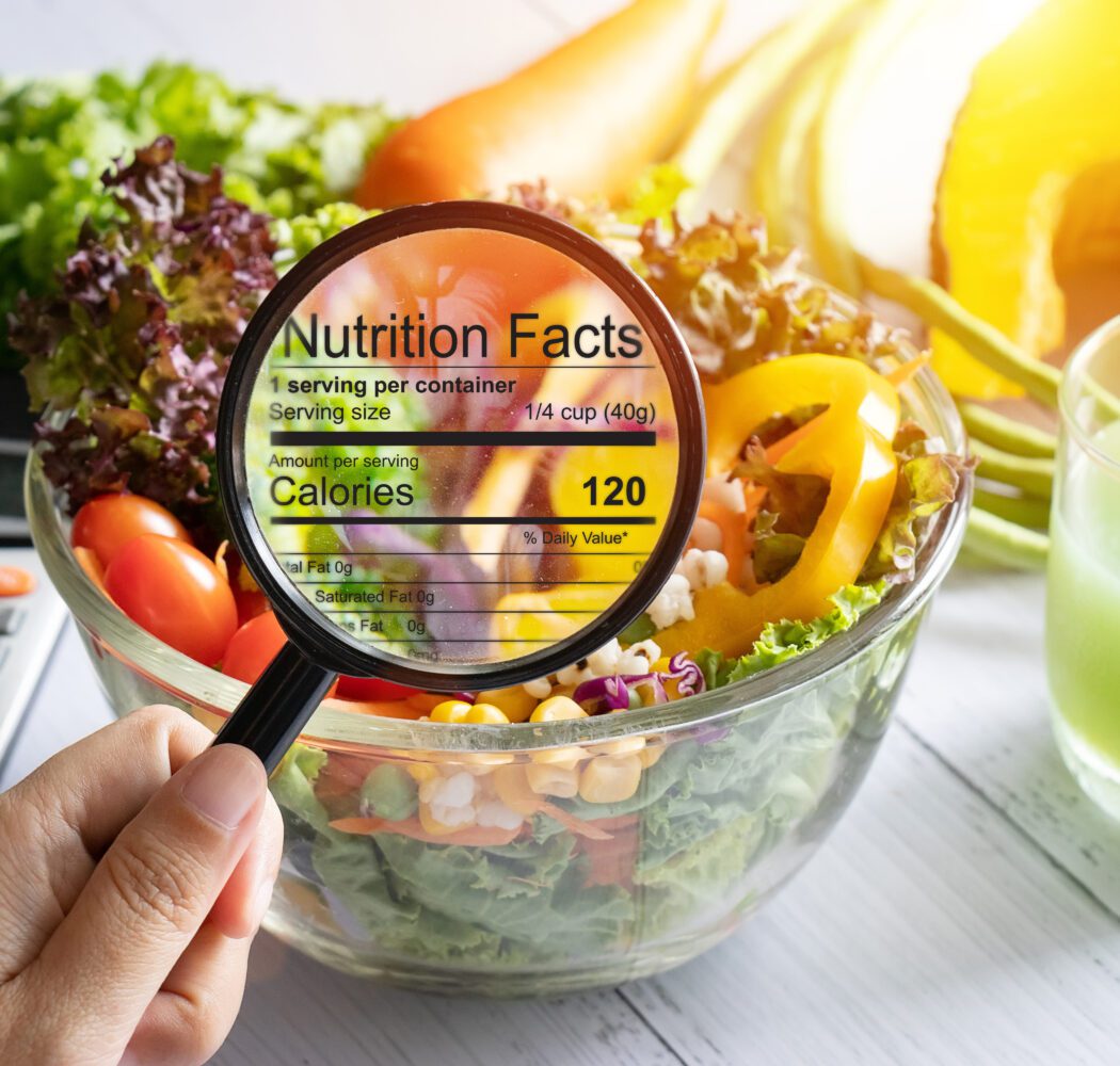 nutritional information concept. hand use the magnifying glass