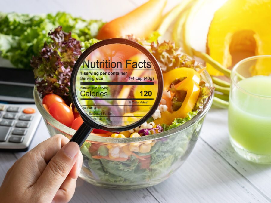 nutritional information concept. hand use the magnifying glass