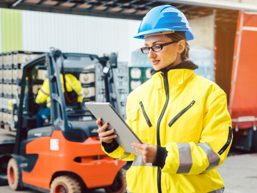 A supply chain leader checks supplier messages and documentation on their tablet device.