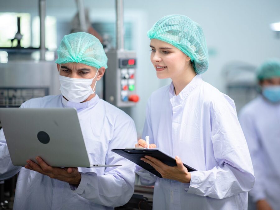 food technician control checking production line of water drink in manufacturing factory