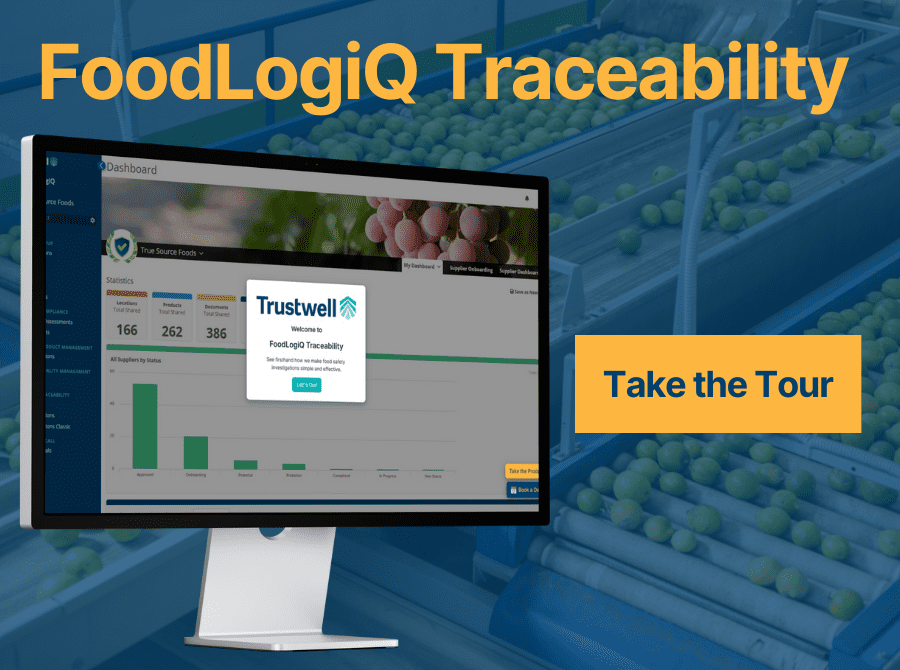 A computer screen displays the FoodLogiQ Traceability dashboard with Trustwell branding, set against a background of a produce processing facility. Text reads "Take the Tour."